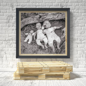 Three abandoned dolls photographed in black and white