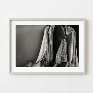 Dust covered clothes hanging inside an abandoned Bahamas house
