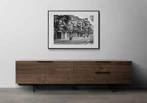 Black and white Vietnamese street scene with aging facades