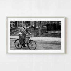 Black and white photograph of bearded cyclist in Toronto