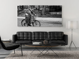 Side profile of older bearded man riding a bicycle
