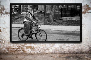 Black and white Toronto street scene with moving cyclist