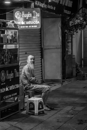 Black and white street portrait of elderly man with long beard in Hanoi