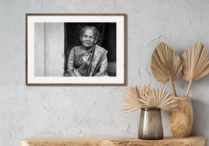 Indian woman with gray hair and weathered face in monochrome portrait