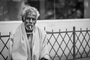 Black and white portrait of an older man with a cigarette