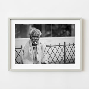 Elderly man smoking in Mysore India in black and white