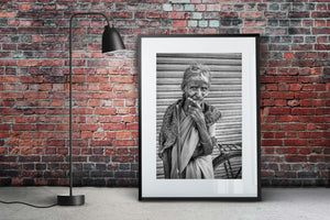 Elderly woman covering her mouth with one hand
