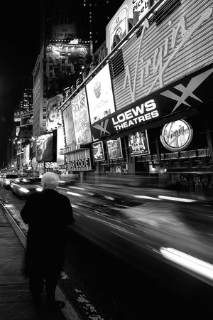 Black and white Times Square street scene with solitary woman