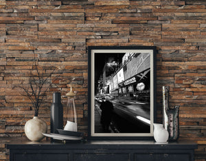 Vertical Manhattan night scene with woman and blurred city traffic