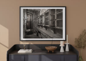 Peeling walls and dusty storage cabinetry in abandoned hospital