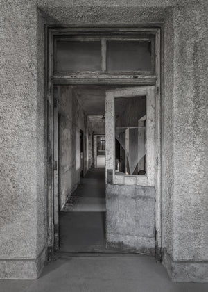 Black and white Ellis Island Hospital corridor and old door