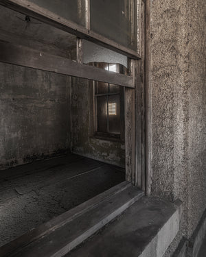 Broken glass and wood framing inside abandoned Ellis Island Hospital