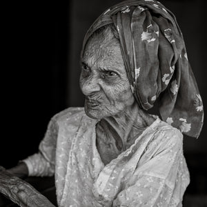 Elderly Indian woman wearing a patterned headscarf