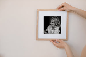 Black and white Indian street portrait with dark background