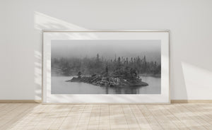 Rocky island surrounded by calm lake water