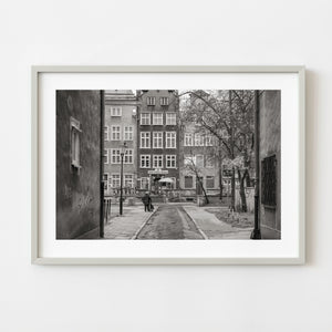 Black and white Gdansk laneway framed by tall urban walls