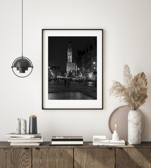 Black and white Gdansk cityscape with streetlights and wet pavement