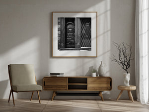 Black and white urban architecture with door lettering and a repeating metal grille