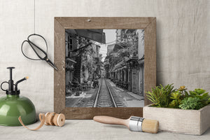 Hanoi Train Street with cafe chairs awnings and railway tracks