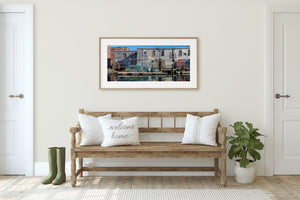 Old wooden waterfront building reflected in harbor water in Maine