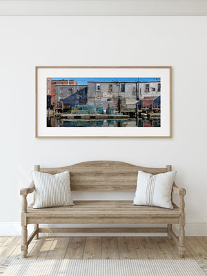 Working harbor scene with lobster traps and aged waterfront architecture