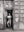 Black and white Havana street photograph of man standing in aged doorway