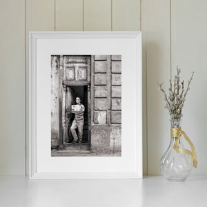 Weathered doorway and man in an everyday Havana street scene