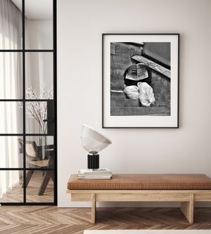 Black and white photo of newspaper reader against textured stone walls