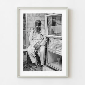 Black and white portrait of an Indian man wearing a motorcycle helmet