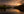 Warm orange sky reflected across calm water