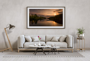 Dark shoreline and bronze reflections at sunset