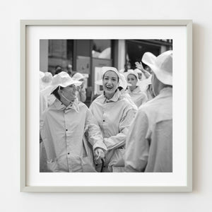 Black and white photograph of women laughing at a Tuscan wine festival