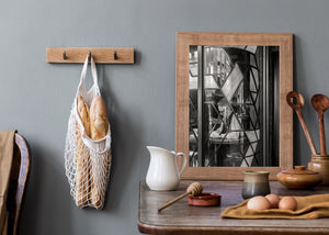 Dark geometric window leading crosses a seated figure and reflections of London architecture.