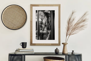 London pub window portrait with curved panes, angular leading and layered street reflections.