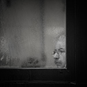 Toronto man partially obscured by condensation on glass