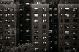 Manhattan apartment building covered with rows of windows and air conditioners