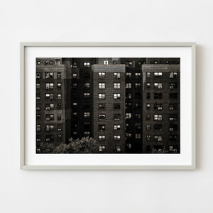 Monochrome Manhattan brick apartment facade with repeating windows