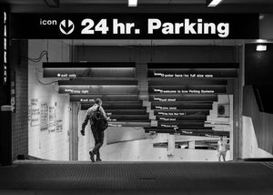 Two men walking down a New York parking garage ramp