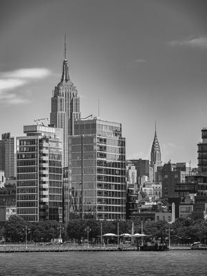 Empire State Building above Manhattan waterfront in black and white
