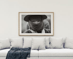 Man wearing a wide brimmed hat and textured face covering