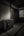 Black and white Japanese interior with an old chest, sliding wooden doors and a glowing shoji screen.