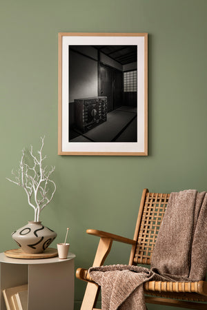 A historic Japanese chest and wooden sliding panels emerge from deep interior shadow.