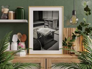 Close black and white view of a book, low stand and shelves of bound volumes in Matsue.