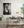Black and white Japanese interior with layered doorframes, ceiling beams and tatami borders.