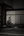 Black and white Japanese interior with a historical samurai figure seated before shoji screens.