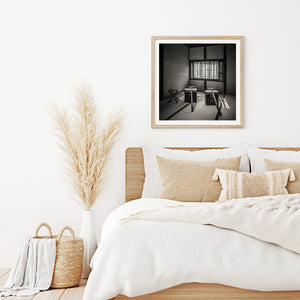 Long wooden poles rest against worn portable chests in a historic Matsue room.