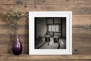 Square monochrome view of samurai-era travel equipment displayed inside Matsue's Samurai Residence.