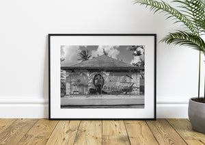 Abandoned Bahamas building with woman mural and barbed wire fence