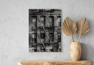 Geometric shadows across a New York City brick building facade