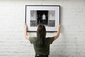 Black and white Cuban street scene inside a weathered barber shop
